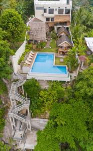 an aerial view of a house with a swimming pool at The Cliffhouse Samboan in Samboan +24 photos