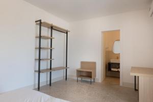 a bedroom with a book shelf and a table at Masseria l'Ulìa in Gallipoli