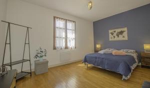 een slaapkamer met een bed, een ladekast en een raam bij Maison des 3 lacs in Chavanges