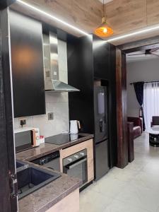 a kitchen with a sink and a stove top oven at Big Mo Bev and Grill in Middelburg