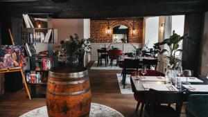 a restaurant with tables and chairs and a wine barrel at Momento Heidkrug in Lüneburg