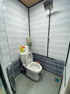 a small bathroom with a toilet in a stall at Umishah Cabin Jitra in Jitra