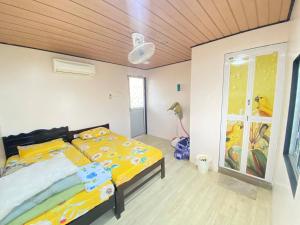 a bedroom with a bed and a wooden ceiling at Umishah Cabin Jitra in Jitra