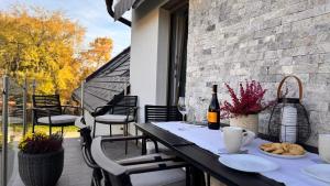 a table with a bottle of wine on a patio at Weekend House Alsóörs in Alsóörs