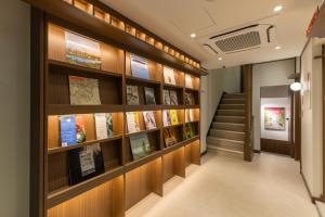 a hallway with bookshelves and stairs in a building at Vinetree Boutique Hotel in Seoul
