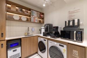 a laundry room with a washer and dryer at Vinetree Boutique Hotel in Seoul