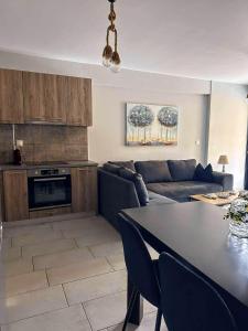 a living room with a couch and a table at EXOTIC LUXURY APARTMENT in Nikiana