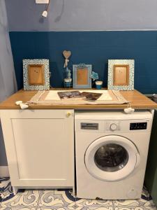 a washing machine with a counter on top of it at Palazzo Rubina - Dimora mediterranea & SPA in Torre del Greco