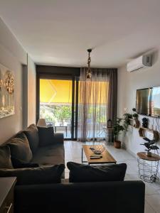 a living room with a couch and a table at EXOTIC LUXURY APARTMENT in Nikiana