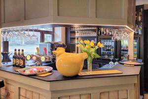 a kitchen with a yellow vase on a counter at Au Coeur d'Alle by Belvilla in Alle