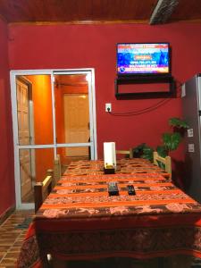 a dining room with a table and a television on a wall at Casa privada en Maimara in Maimará +7 photos