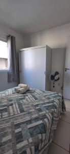 a bedroom with a bed with a blanket on it at Apartamento em Imbituba in Imbituba +24 photos