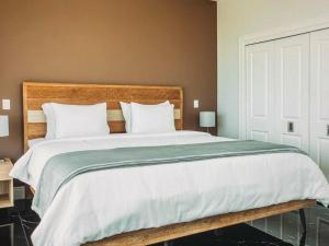 ein Schlafzimmer mit einem großen Bett mit einem hölzernen Kopfteil in der Unterkunft Spectacular views Atlantic Ocean in Basseterre + 8 Fotos