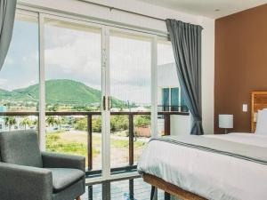 a bedroom with a bed and a large window at Spectacular views Atlantic Ocean in Basseterre
