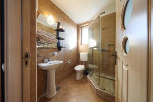 a bathroom with a toilet and a sink and a shower at Casa la Martin in Comarnic +38 photos