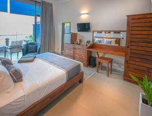 a bedroom with a bed and a desk with a computer at Mawakada Bay Residences in Hikkaduwa