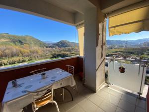 a table and chairs on a balcony with a view at B&B Olimpia in Cosenza