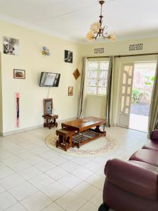 a living room with a table and a couch at KidotuiVillaHome in Arusha