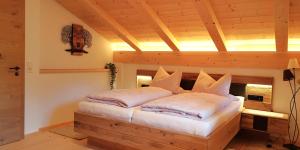 a bedroom with a bed in a log cabin at Alpenchalet-Chiemgau in Marquartstein