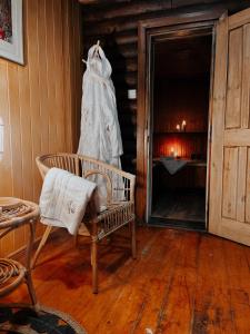 a room with a chair and a dress hanging on a wall at Hotel Star Dadaj Resort & Spa in Dadaj