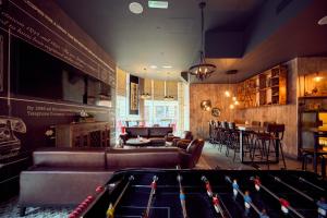 a billiard room with a pool table and a bar at a&o Manchester City Centre in Manchester