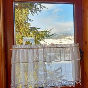 a window with a view of a beach at Domek u Stolarza in Grywałd