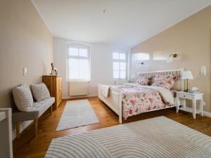 a bedroom with a bed and a couch at Alte Schule Rietz in Treuenbrietzen