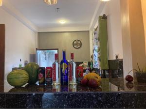 a counter top with fruits and bottles on it at Hurley vila in Weligama