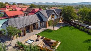 an aerial view of a house with a yard at Pensiune Old Barn House in Vàrhegy