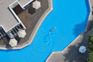 an overhead view of a person swimming in a pool at Kiotari Miraluna Beach Resort in Kiotari