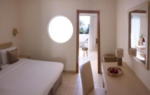 a bedroom with a bed and a table with a bowl of fruit at Kiotari Miraluna Beach Resort in Kiotari +151 photos
