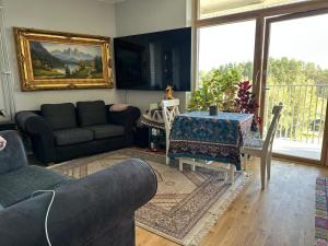 a living room with a couch and a table at Amir in Järfälla