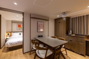 a room with a bed and a table and chairs at Vinetree Boutique Hotel in Seoul +33 photos