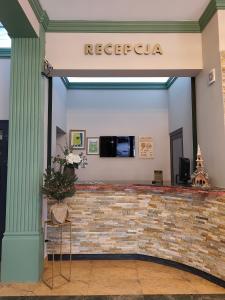 een lobby van een hotel met een bakstenen muur bij Pensjonat Cezar in Siemiatycze
