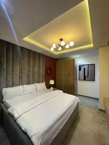 a bedroom with a large white bed in a room at Exotic Two bedroom apartment in Abuja