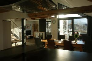 a dining room with a wooden table and chairs at Haus & Apartment am Lahnbach in Schwaz