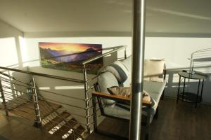 a room with a chair and a painting on the wall at Haus & Apartment am Lahnbach in Schwaz