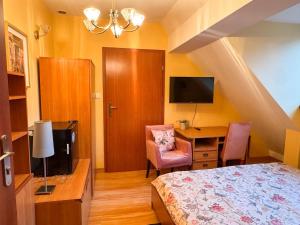 a bedroom with a bed and a desk and a table at Terra Siciliana in Łęczyca