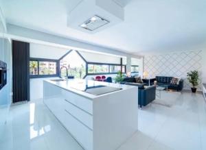 a kitchen and living room with a white counter top at Appartement luxe hivernage in Marrakesh