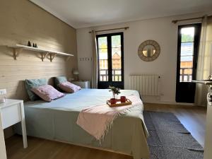 a bedroom with a large bed with a tray on it at Buenavista Candanchu in Candanchú
