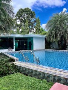 a swimming pool in front of a house at City Garden Olympus condo balcony in Pattaya South