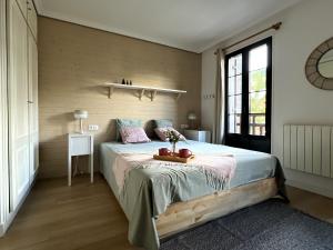 a bedroom with a bed with a table on it at Buenavista Candanchu in Candanchú +9 photos