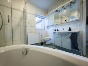 a bathroom with a tub and a sink and a toilet at Alte Schule Rietz in Treuenbrietzen +68 photos