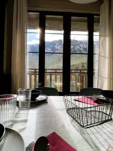 a dining room table with a view of the water at Buenavista Candanchu in Candanchú