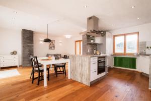 a kitchen with a table and chairs in a room at Benedikt & Wilhelmine in Rettenberg +35 photos
