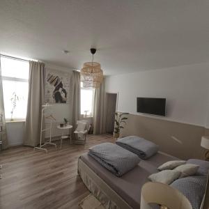 a bedroom with a bed and a tv on the wall at Anno 1889 in Plauen