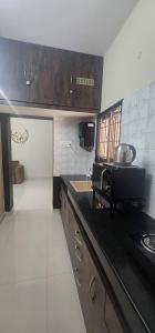 a kitchen with a counter top and a sink at LBS Farmstay in Alāndurai