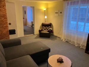 a living room with a couch and a chair at Arkaadia in Viljandi