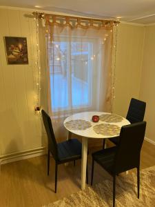 a table and chairs in a room with a window at Arkaadia in Viljandi +6 photos