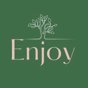 a tree growing out of the ground with the word enjoy at Enjoy suítes in Aracaju